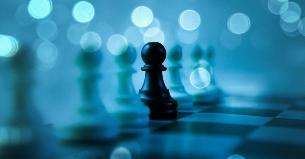 A black pawn stands out on a chessboard.